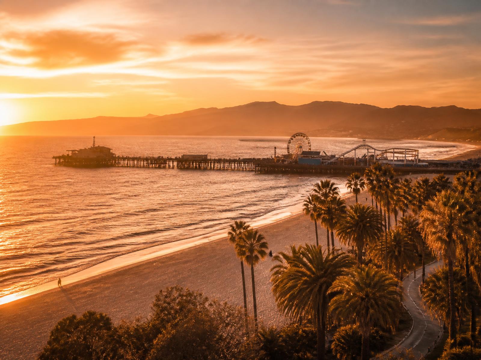 Santa Monica pier and palms at sunset in Los Angeles